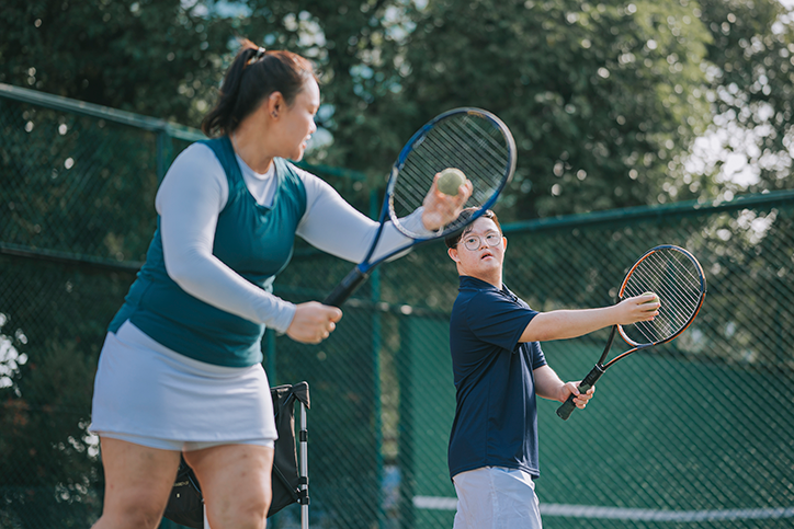 C4S-image-Female tennis trainer coaching a Down syndrome child
