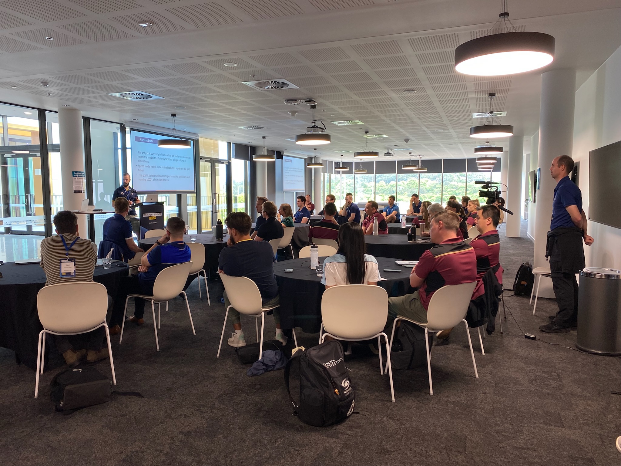 A room full of people and a presenter