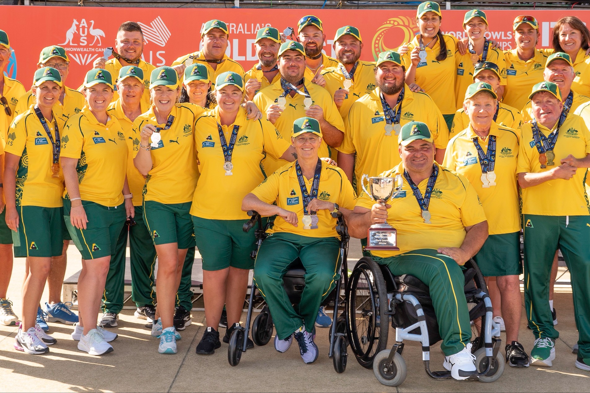 Ellen Falkner pictured with the Australian Para bowls team, who are all in their Australian uniform holding their medals and trophy after finishing the 2023 World Championships as the best performing Para Nation, and mens team.