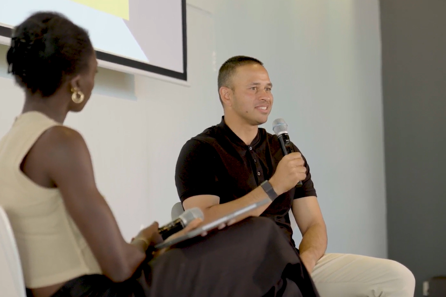 Usman Khawaja seated holding a microphone