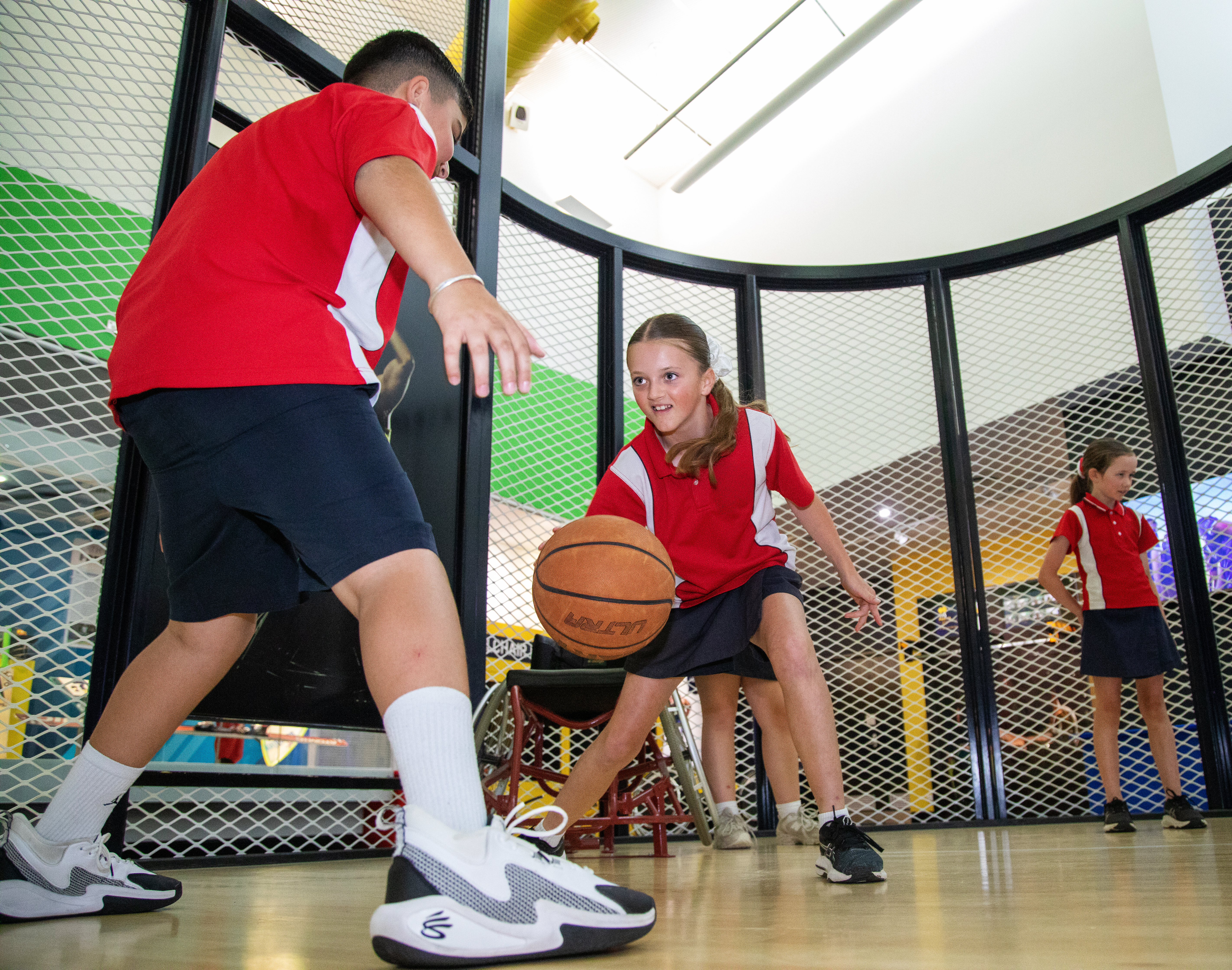 School children playing basketball in Sportex