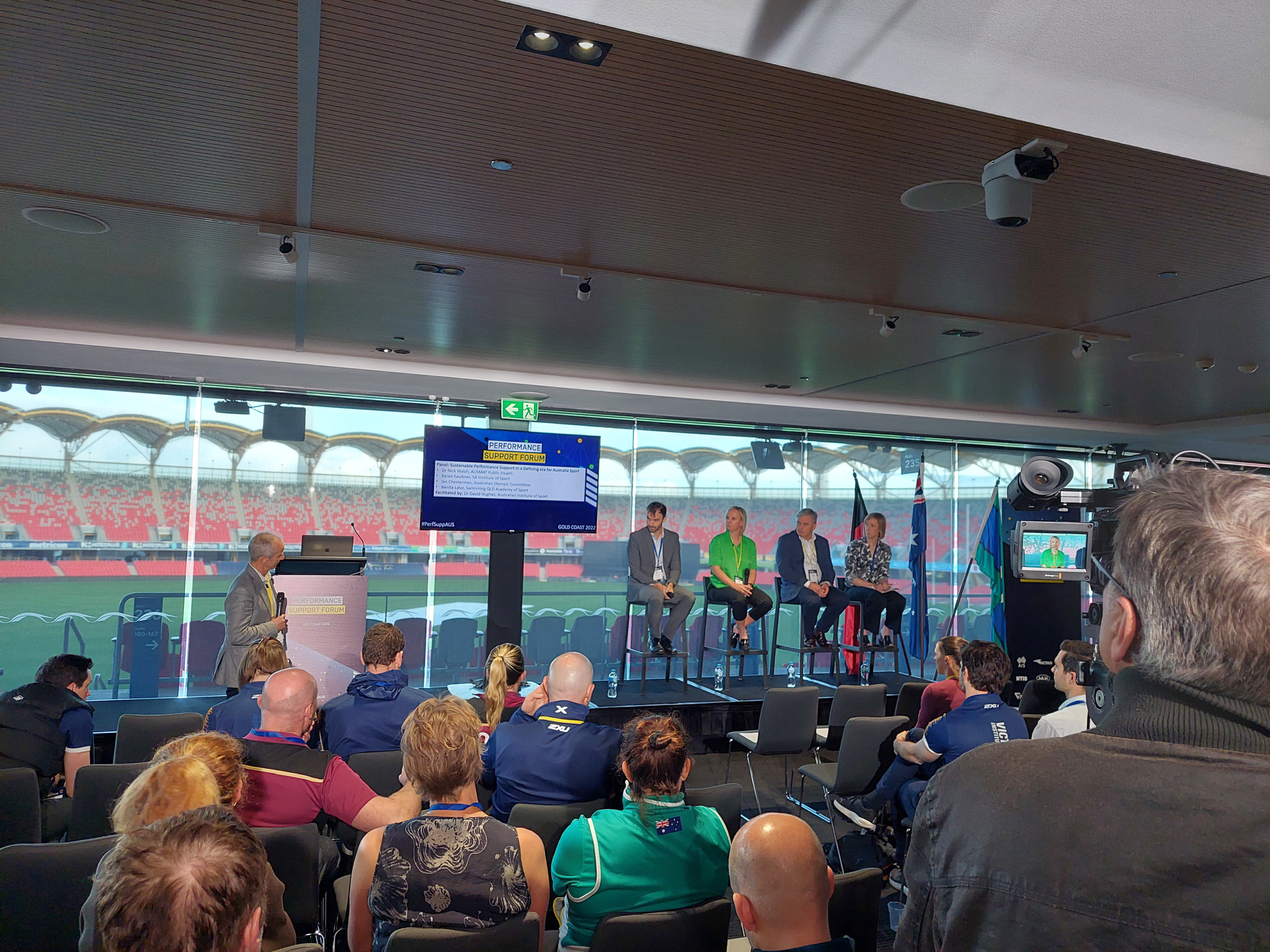 A panel of people speaking at a conference