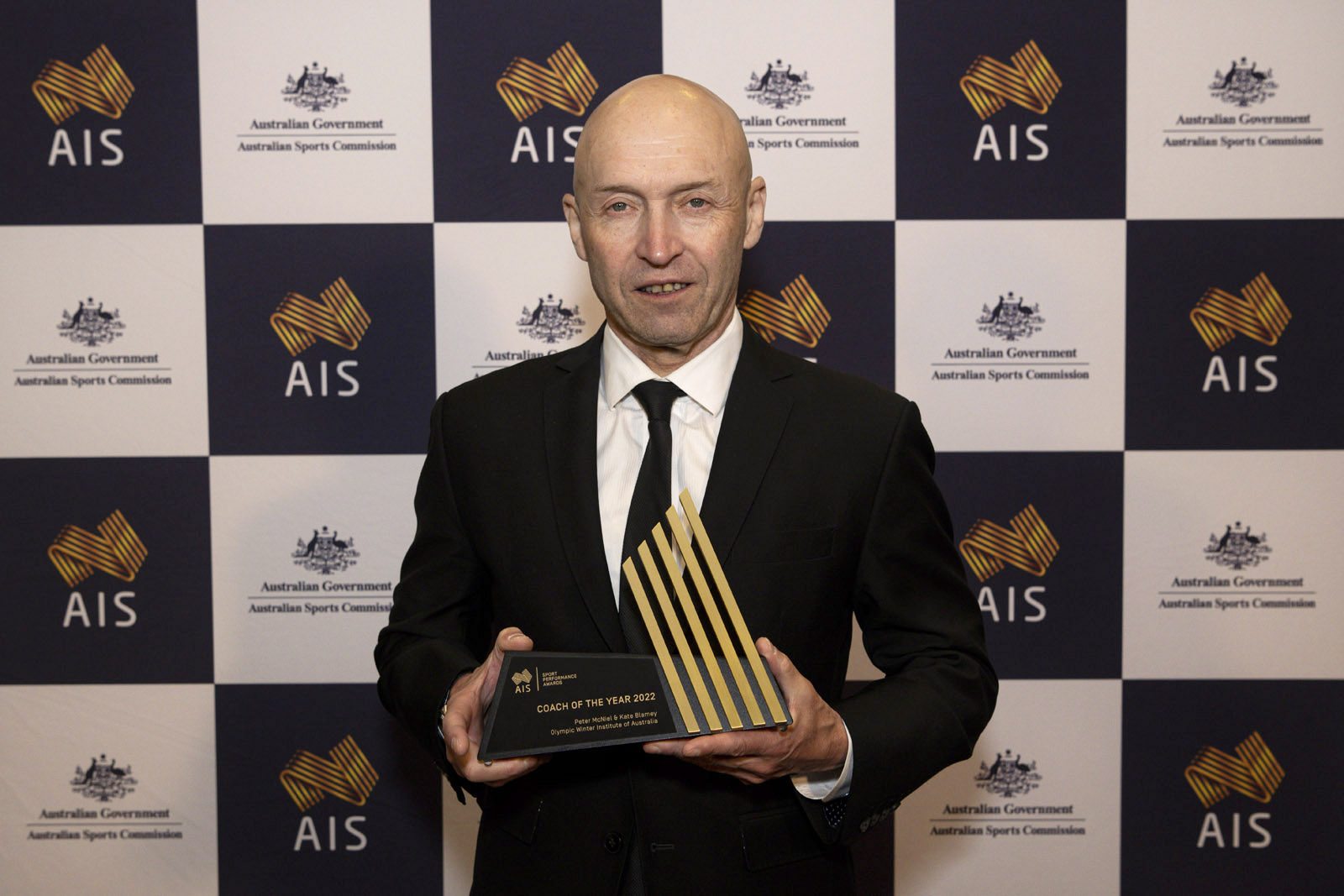 Olympic Winter Institute of Australia CEO Geoff Lipshut accepts the Coach of the Year Award on behalf of the institute's Peter McNiel and Kate Blamey.