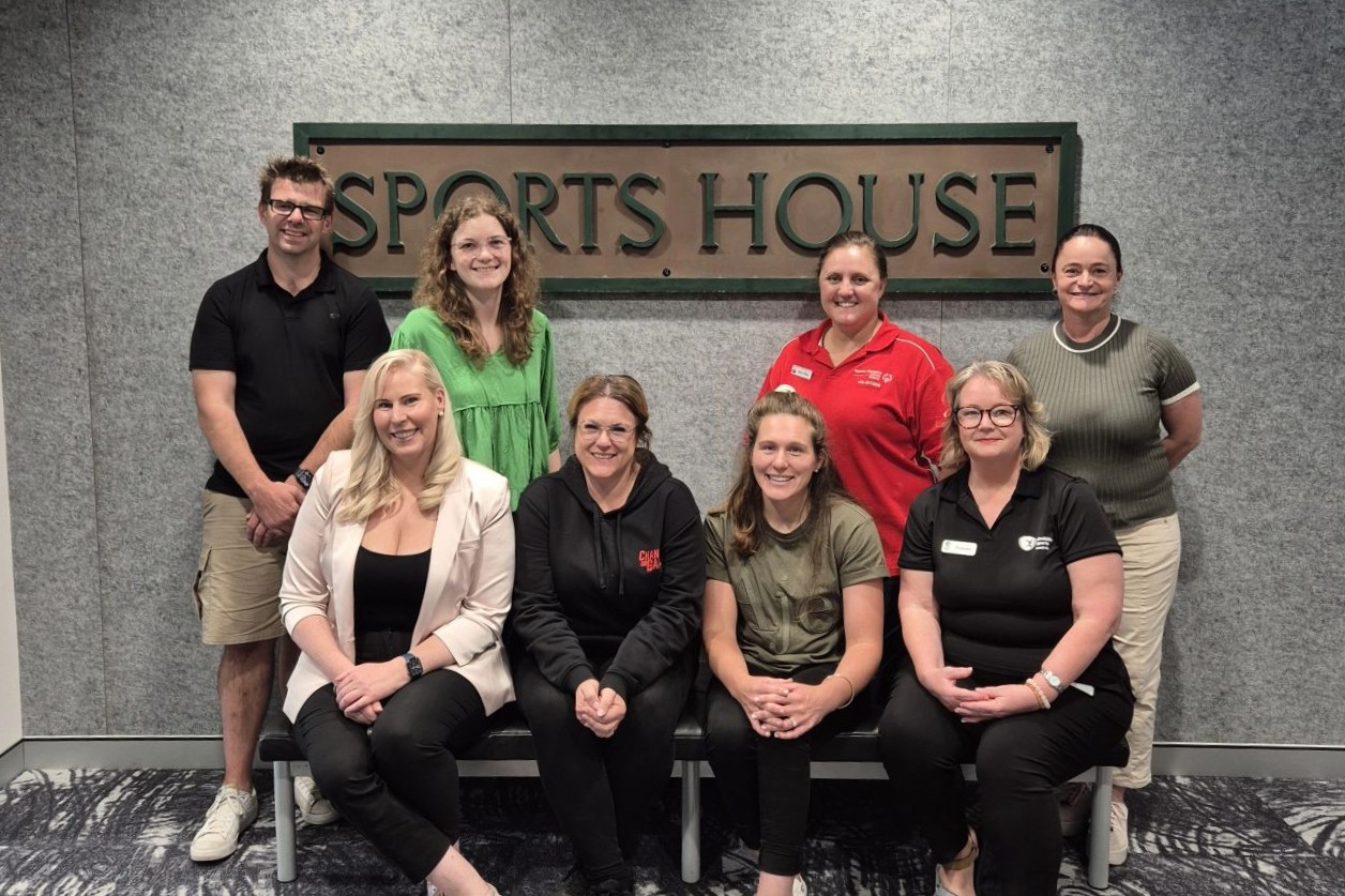 8 members of Disability Sports Australia's Disability Advisory Committee smiling for a photo