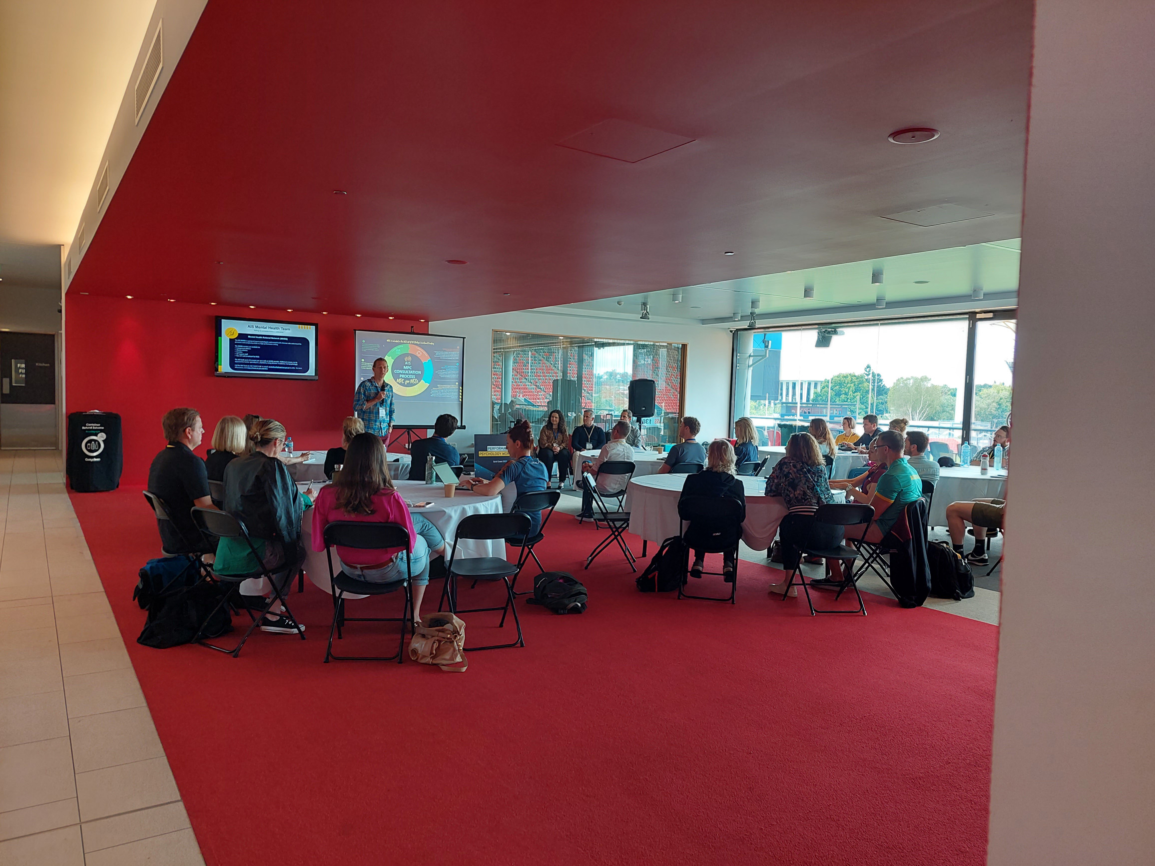 Presenter talking to the crowd at the conference