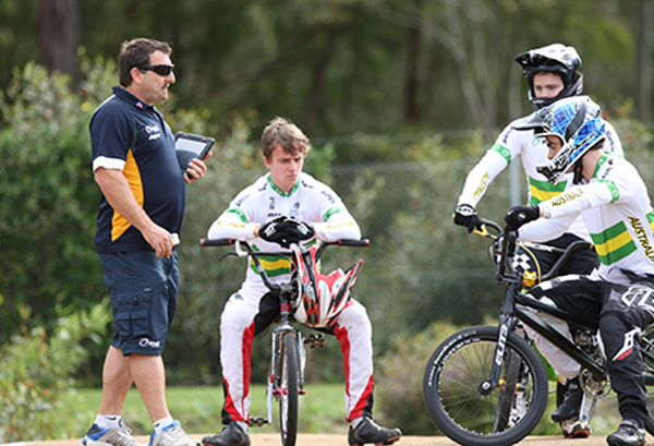 AIS Coach talking to BMX athletes on the track