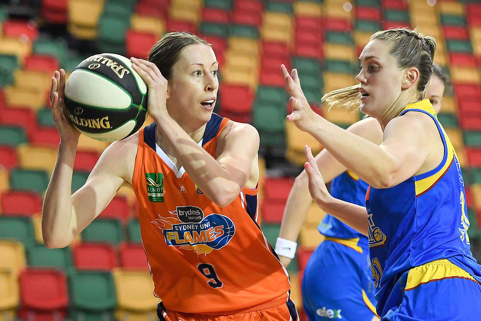 Nat Burton looking to pass a basketball past an opponent