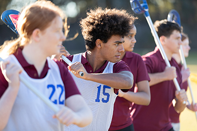 Lacrosse players practicing their throw.