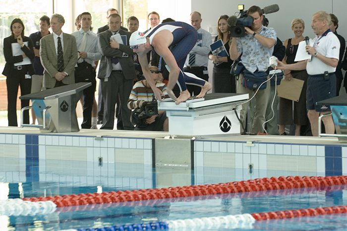Opening of the Swimming Centre and Administration building - AIS athlete Kirk Palmer prepares to dive into the pool on the force measuring start block, while Bruce Mason Head of Aquatics Testing Training and Research conducts performance analysis testing 2006