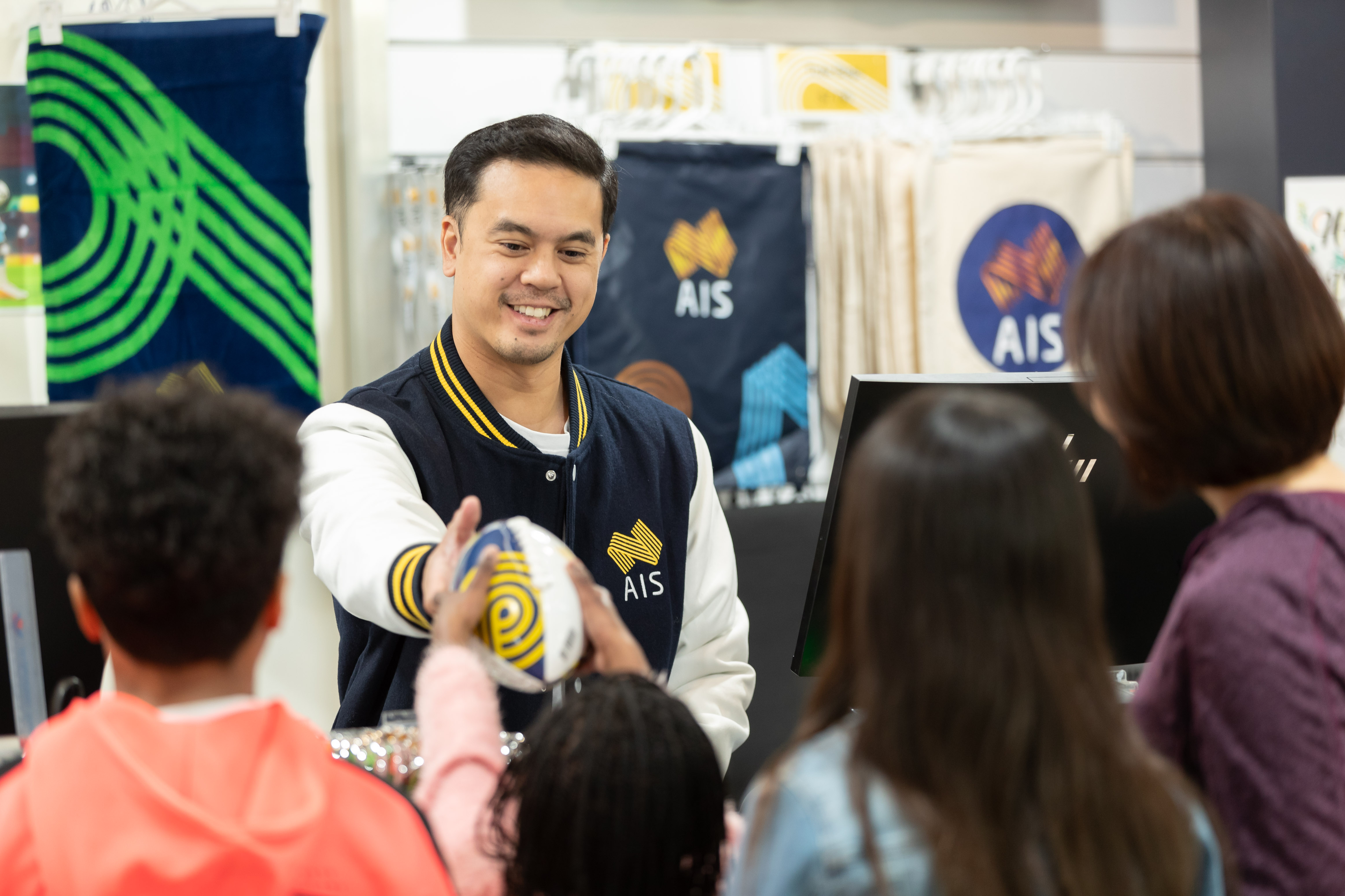 AIS Shop handing child ball
