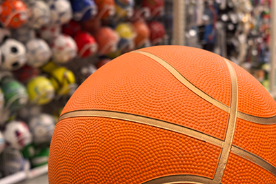 Close-up of a basketball in a sports shop with some other defocused balls in the background.