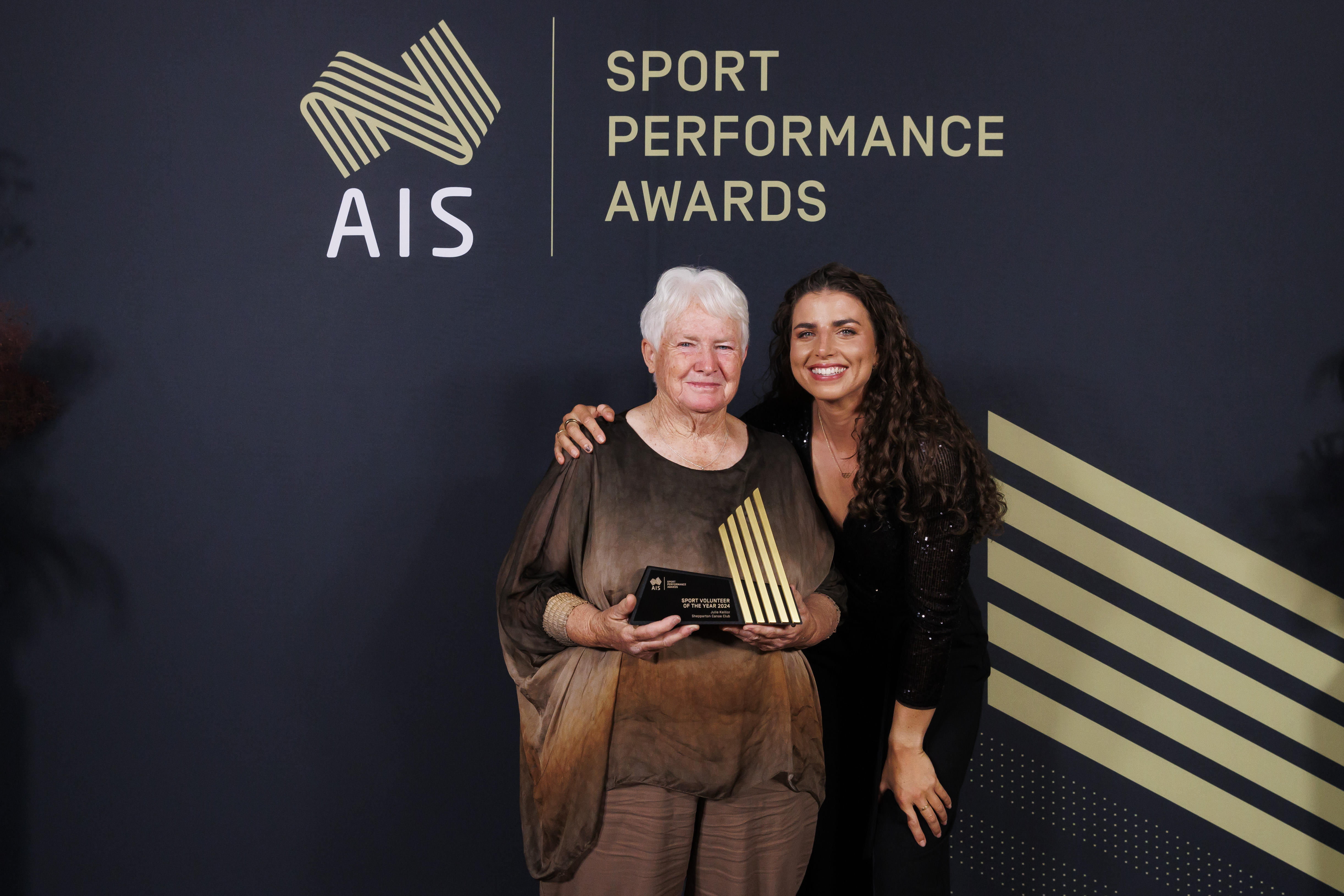 Julie Keillor standing with Jess Fox after winning Volunteer of the Year award at the ASPAs