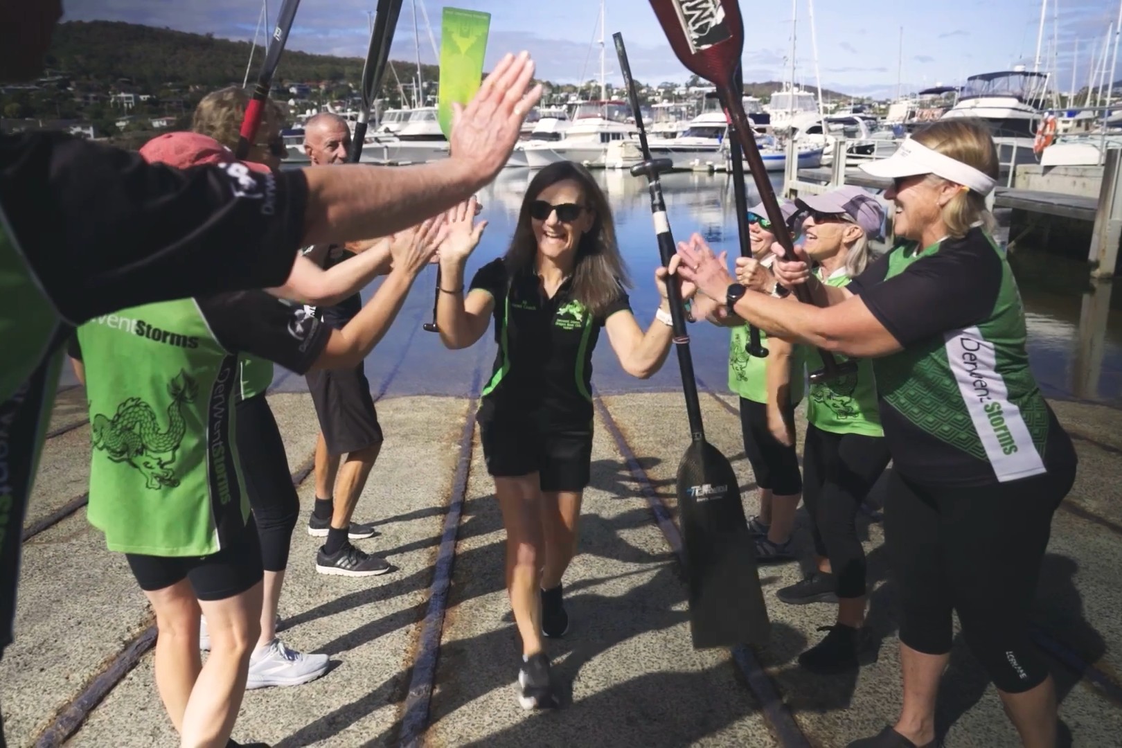 Volunteers are celebrated at a rowing event.