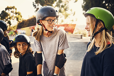 A group of young girls skateboarding together at a skatepark