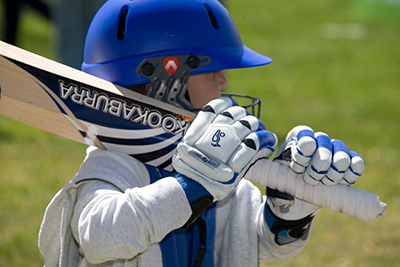 A child with a cricket bat