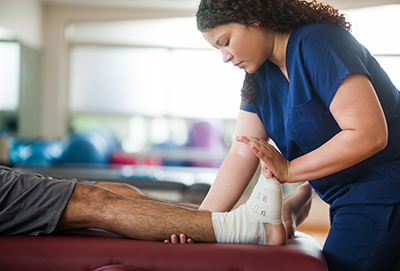 C4S-evidence-cost of sport- physio looking at an injured foot