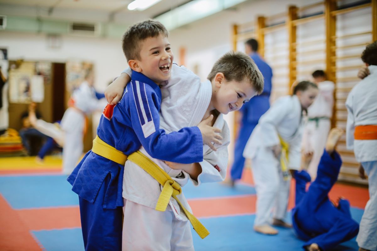 Two young boys doing judo on a mat