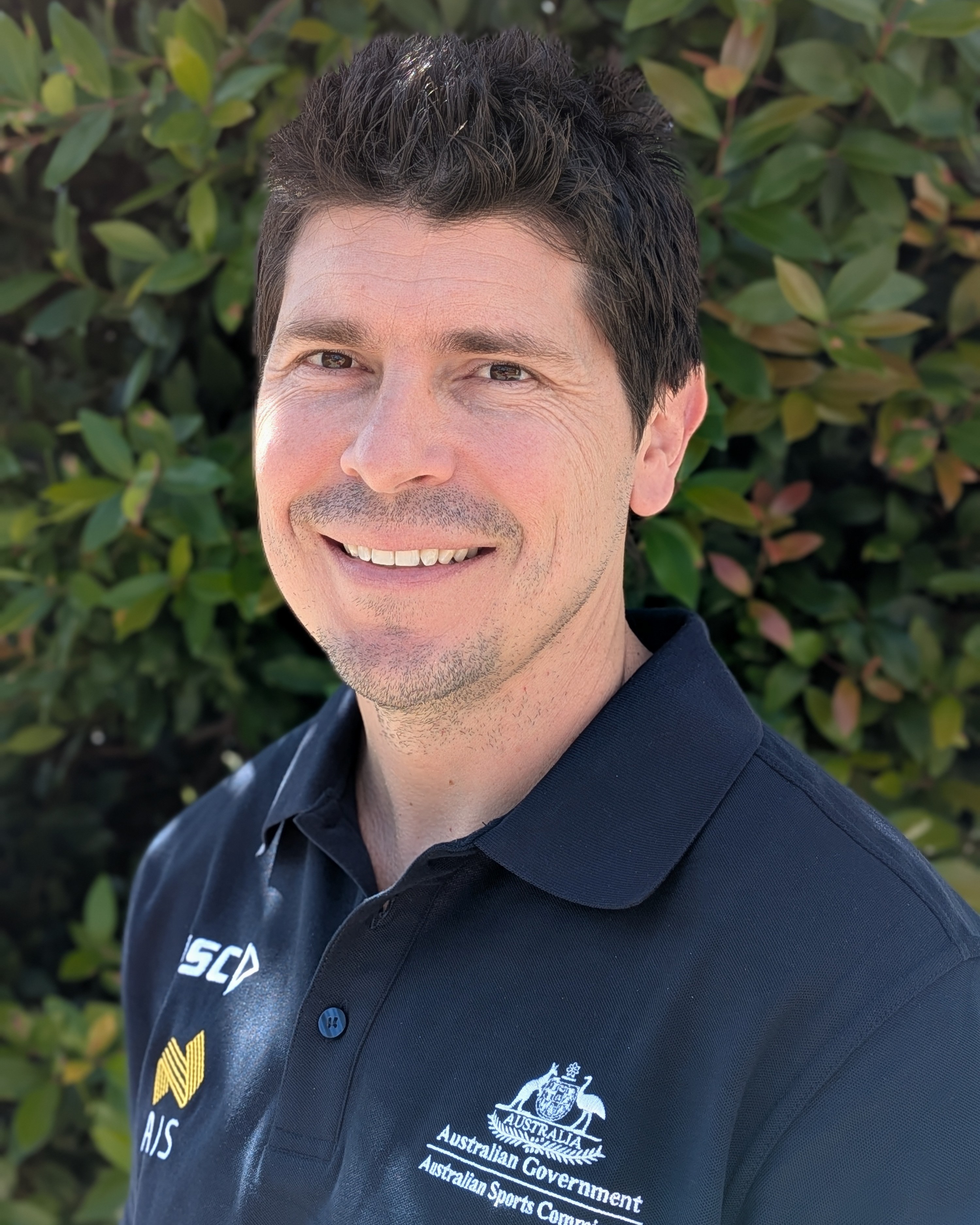 Headshot of Kieran Young wearing AIS polo