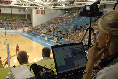 An analysist monitoring a women's netball match