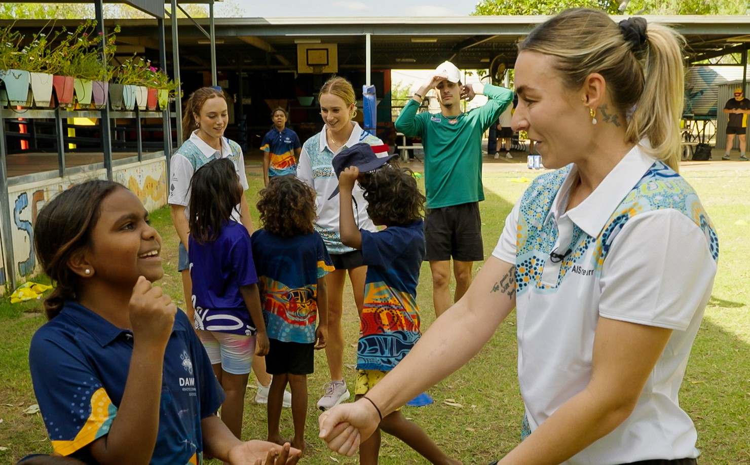 Athletes in the Kimberley interacting with local Aboriginal kids