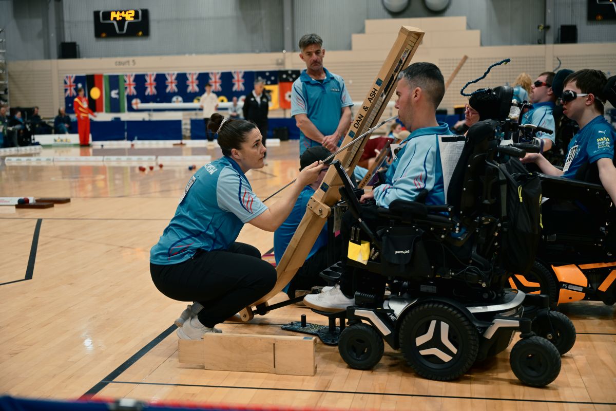 Boccia player Dan Michel and ramp assistant Ash McClure mid-competition on the AIS basketball courts