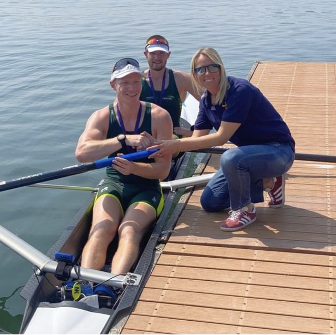 Athletes sitting in their boat on the water