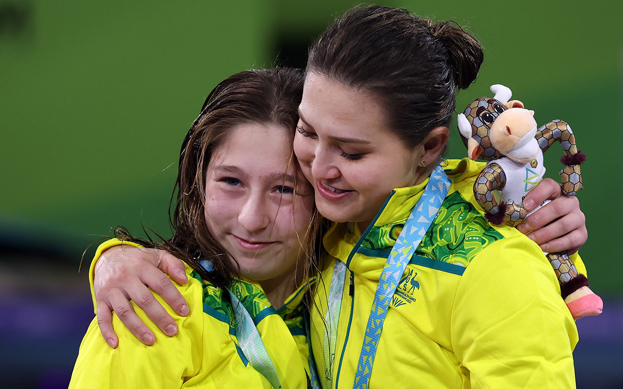 Australia's youngest team member Charli Petrov and Melissa Wu embrace after winning the Women's Synchronised 10m Platform Final at the Birmingham Commonwealth Games. Photo: Getty Images