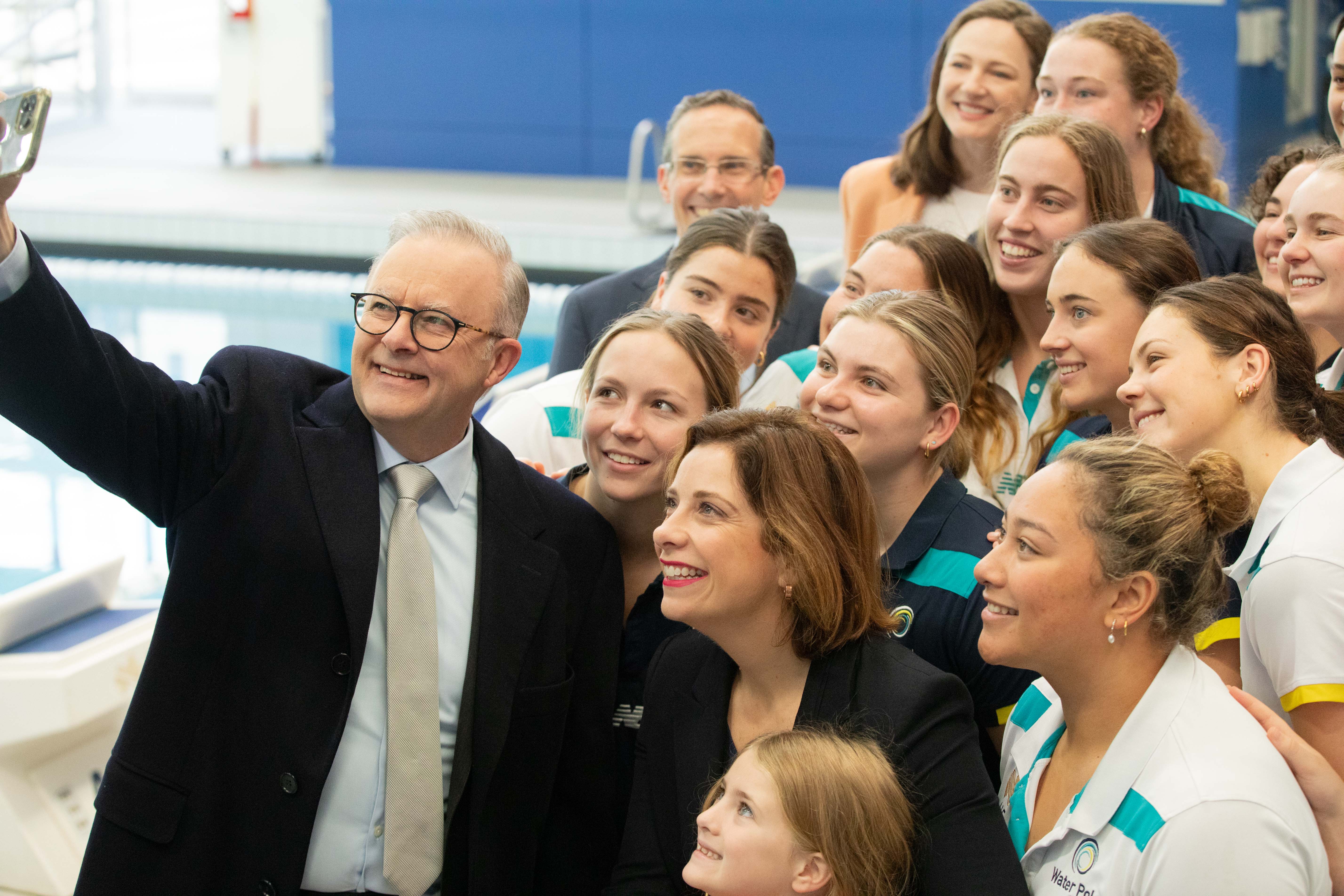 Prime Minister Anthony Albanese, Minister for Sport Anika Wells and Olympian Cate Campbell with members of the Australian junior water polo team.
