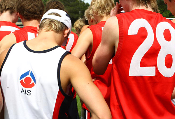 AIS scholarship holders in a team huddle