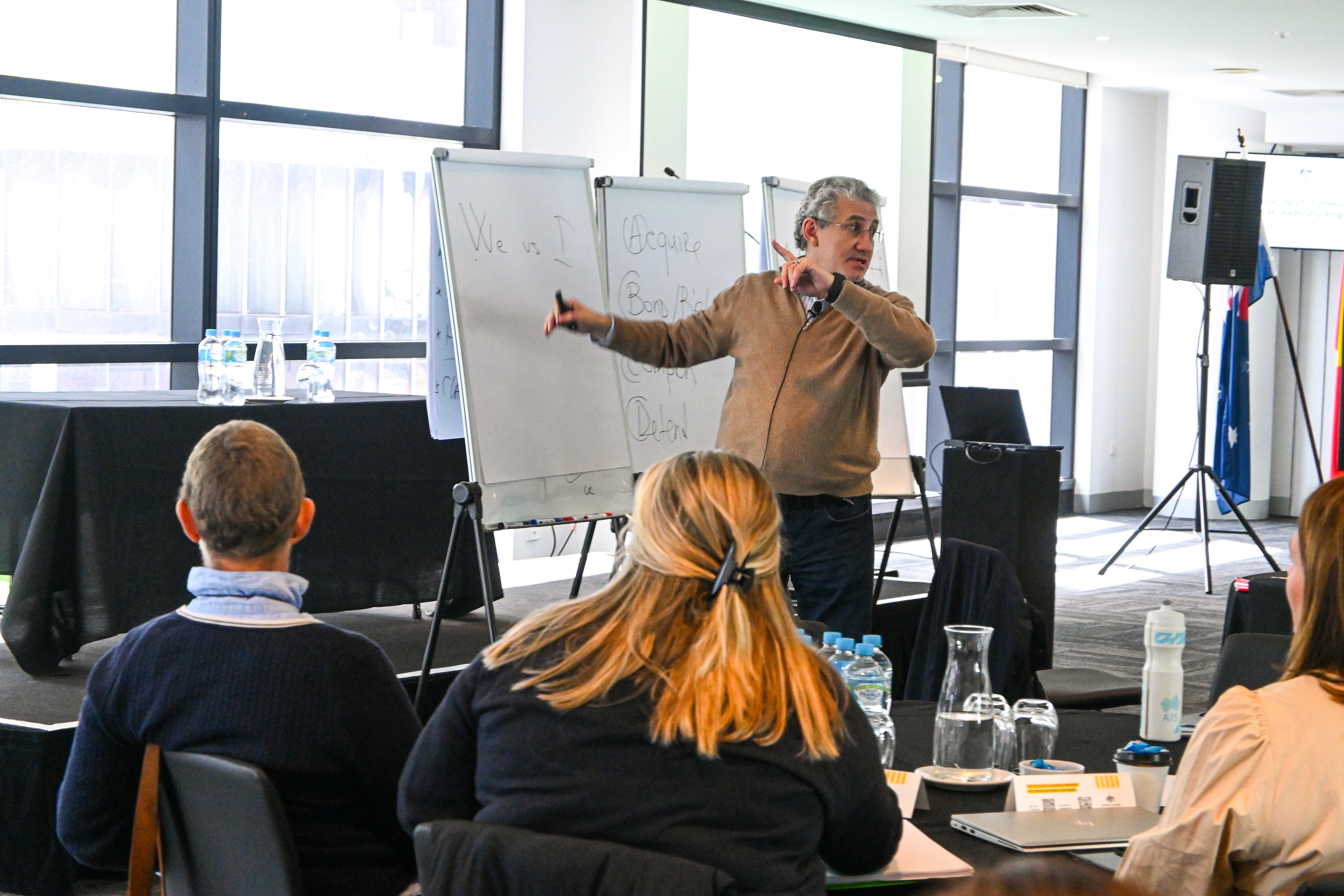 Harvard Business School Professor Boris Groysberg leading a session with all attendees sitting at tables