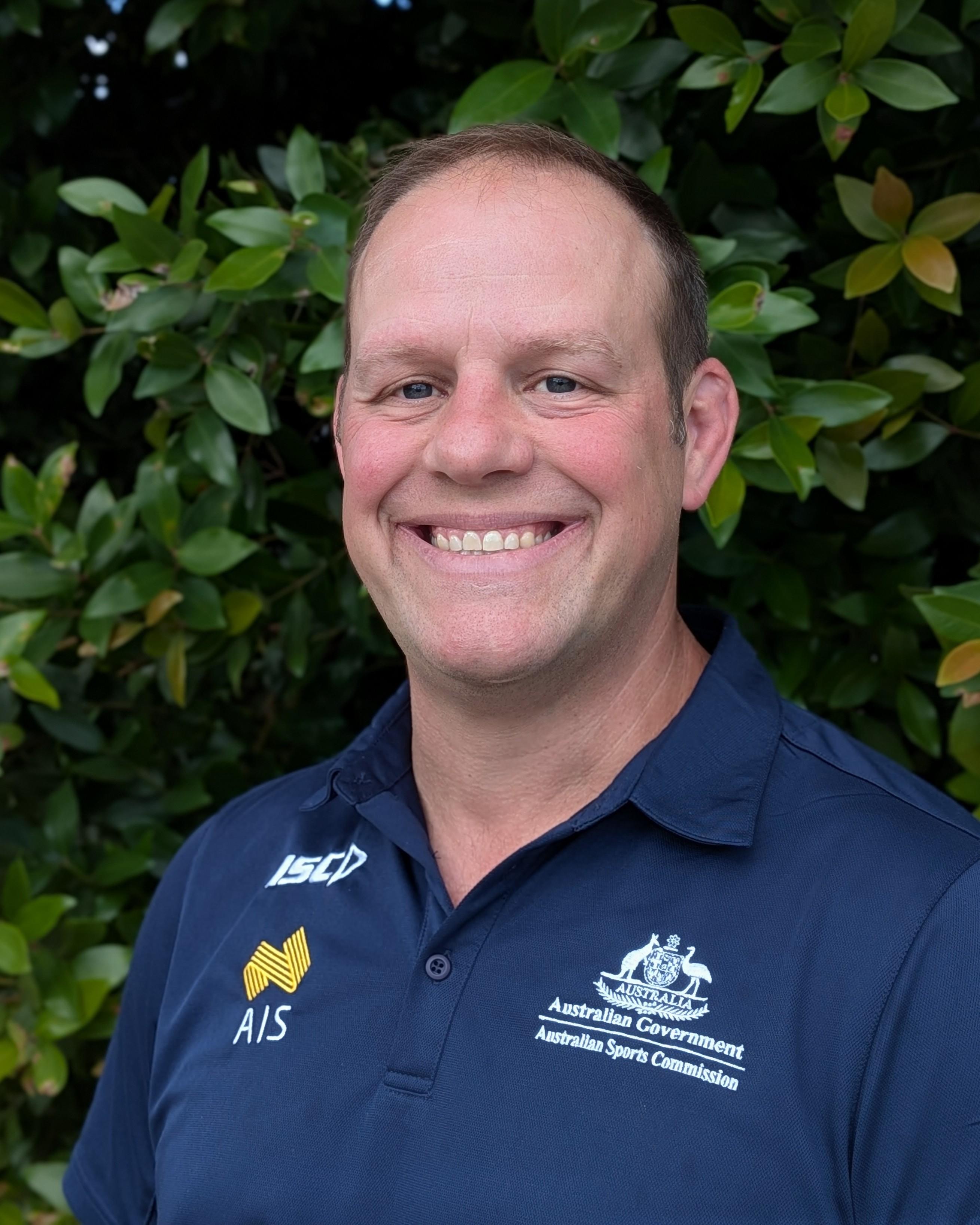Headshot of Derek Panchuk wearing AIS polo