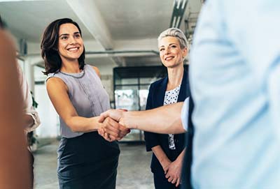 female greeting people in an office