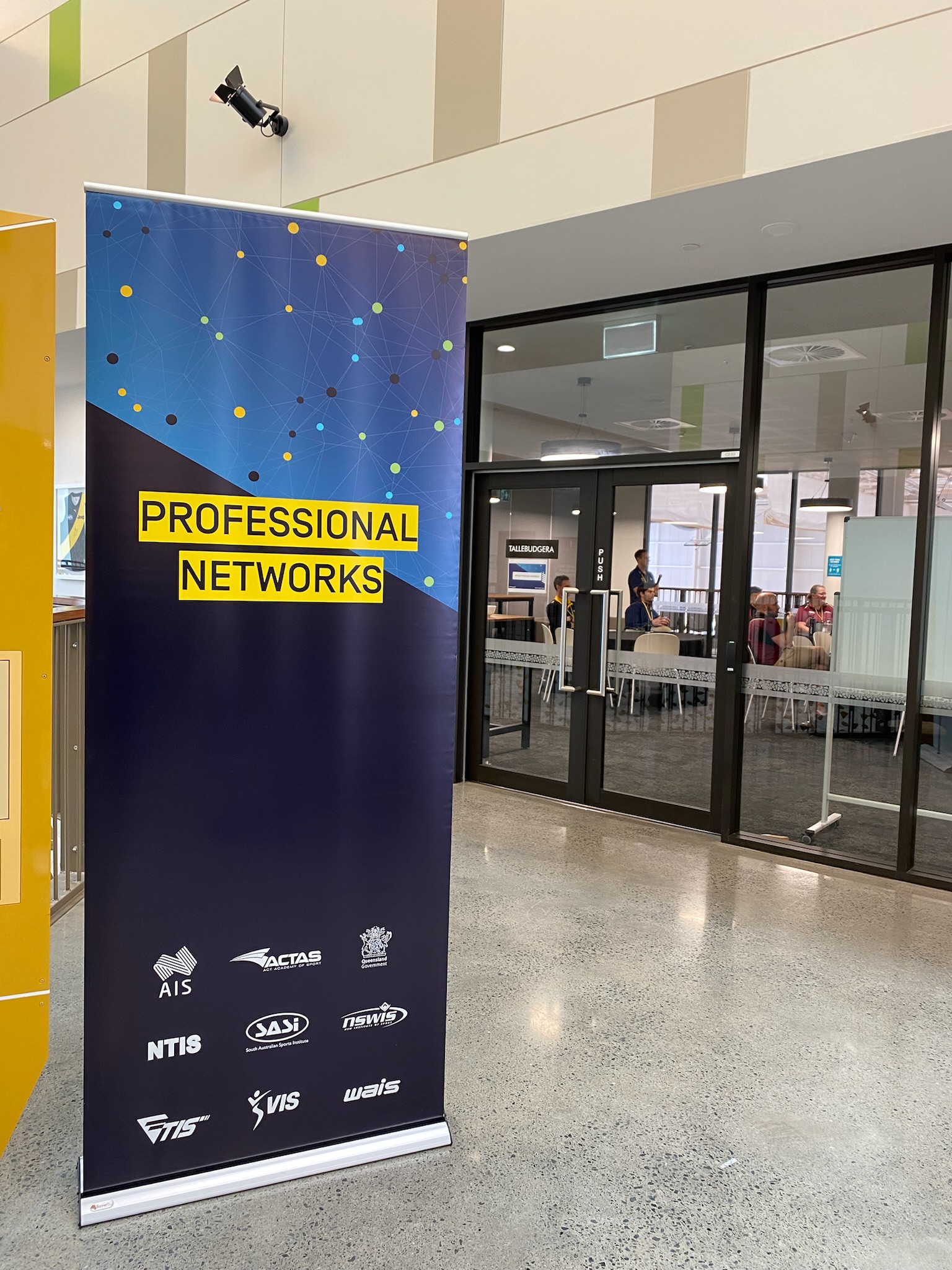 Professional Networks banner in front of glass doors