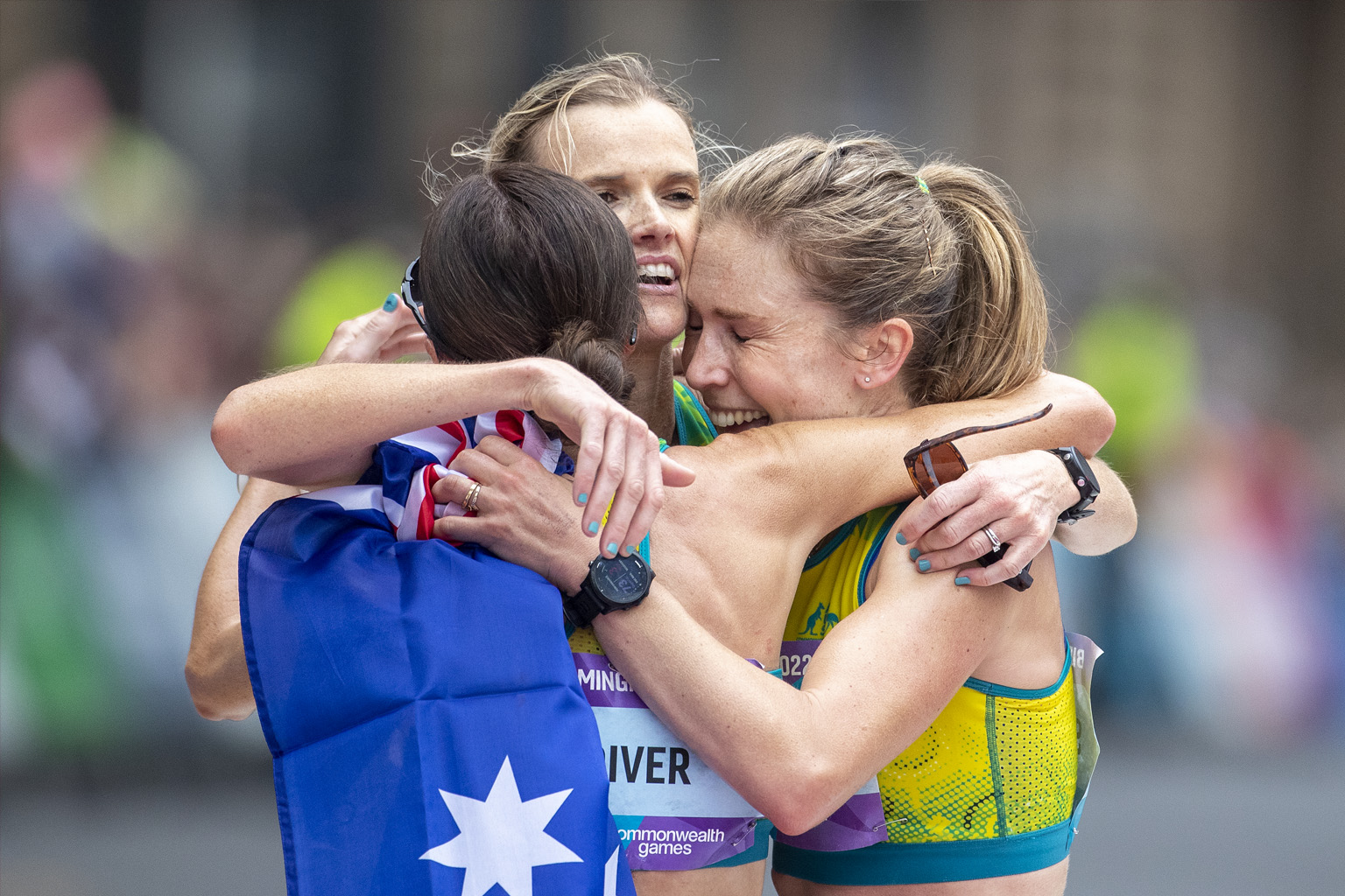 Jessica Stenson of Australia is congratulated by teammates Eloise Wellings and Sinead Diver after the Women's Marathon at the Birmingham 2022 Commonwealth Games.