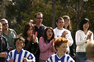 Parents cheering on a sideline