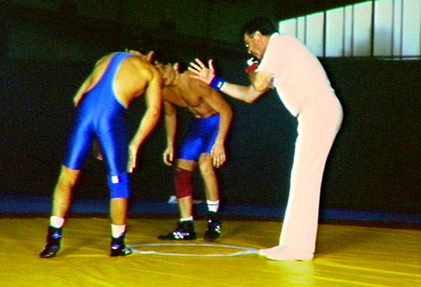 Two wrestlers ready and waiting for the referee
