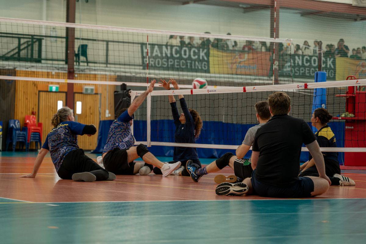 Sitting Volleyball players on the indoor volleyball courts at the AIS
