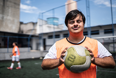C4S-image-young down syndrome boy holding a ball