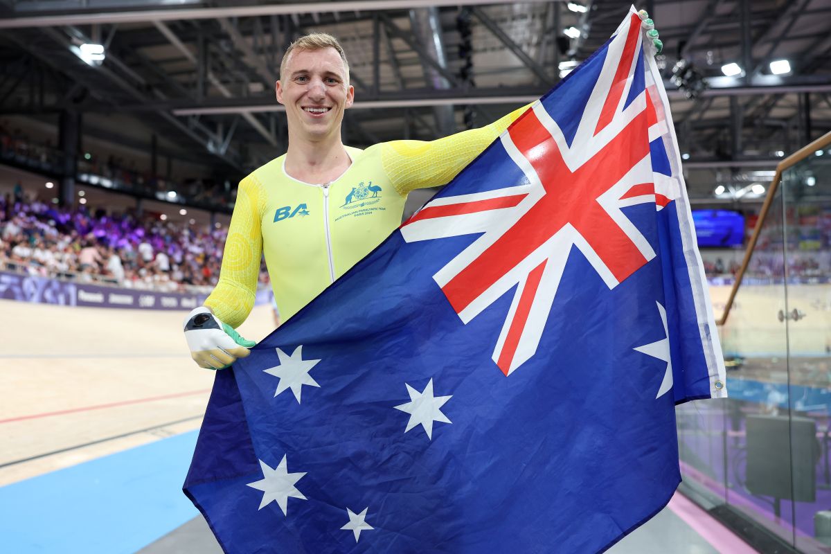 Korey Boddington holding the Australian flag at the 2024 Paris Paralympics