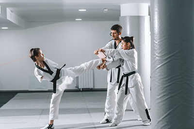 Para Taekwondo athlete kicking a board