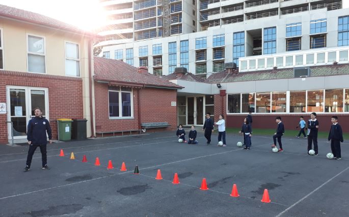 Sporting Schools - Football drills in school courtyard