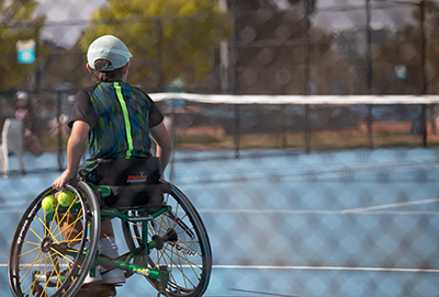 Wheelchair Tennis player holding a racket