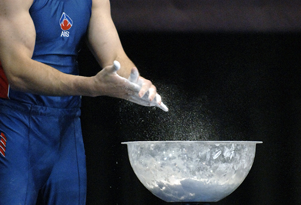Athlete applying chalk to their hands