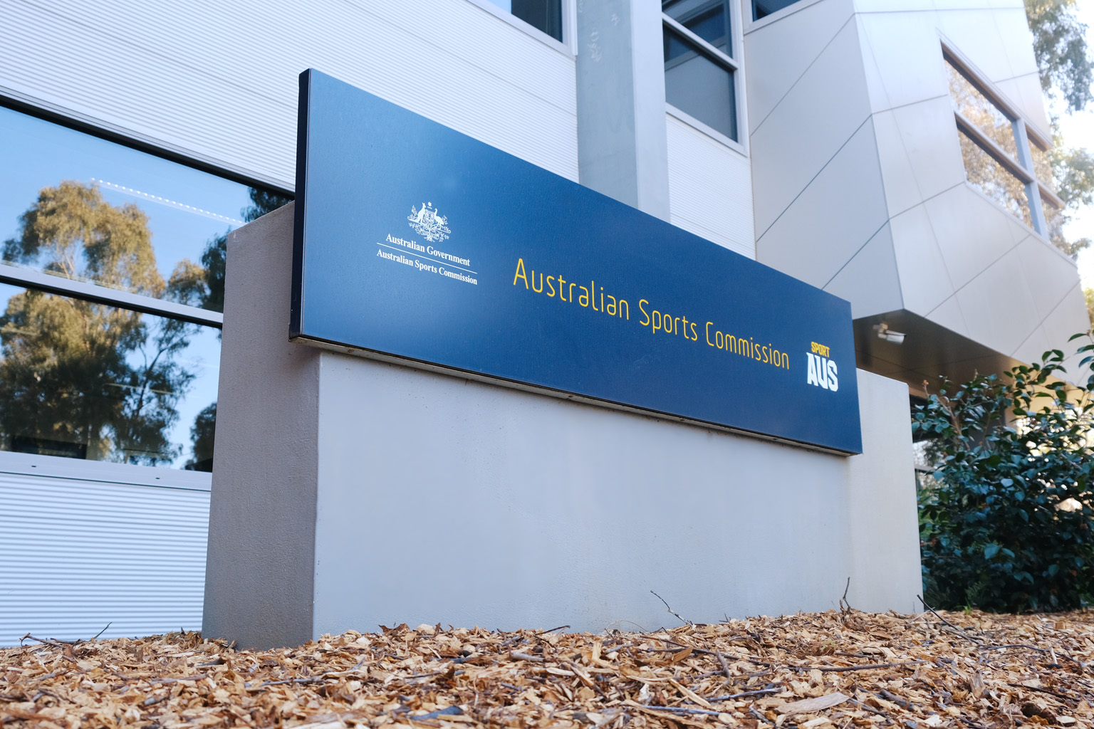 Sign reading Australian Sports Commission with government crest and Sport AUS logos